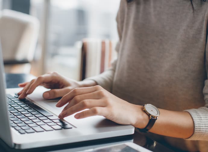 Female hands typing.